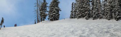 A winter mountain scene of a mogul run.