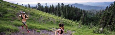 Two trail running on a mountain path.