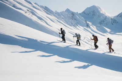 Bryce leading a trek through the snow with others following behind