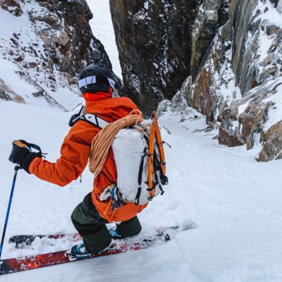 Vivian traversing down a snowy mountain