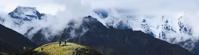 Two climbers walking on a snowy mountainside.
