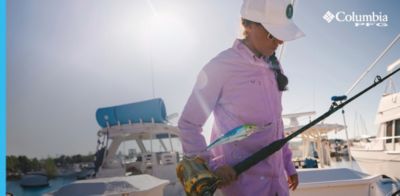 Woman wearing PFG on a dock.