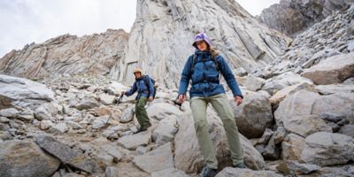 Two alpine climbers make their approach in the high alpine.