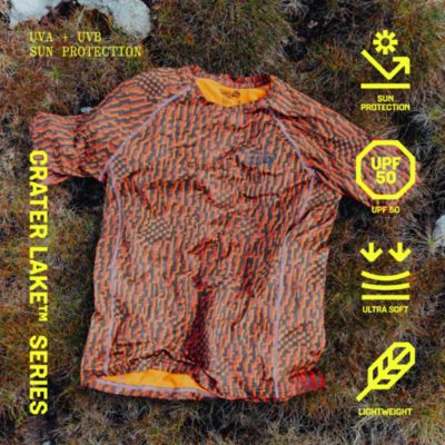 CRATER LAKE SERIES. UVA + UVB SUN PROTECTION. UP50, EXTRA SOFT, LIGHTWEIGHT. Laydown of Crater Lake Short Sleeve Tshirt on mossy green terrain.