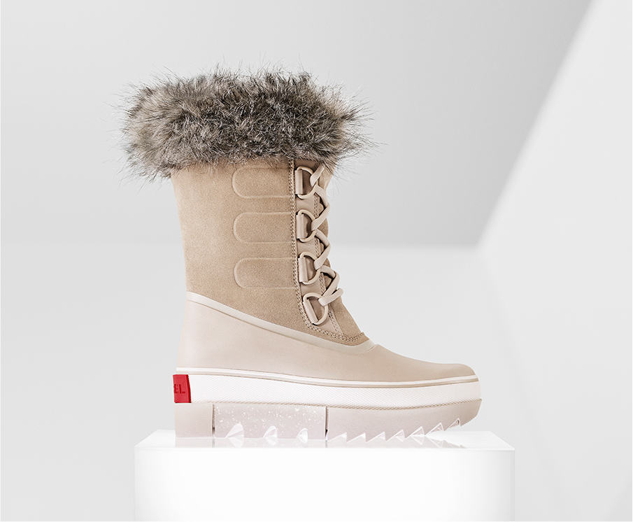 A profile view of a tan Joan NEXT boot on white background