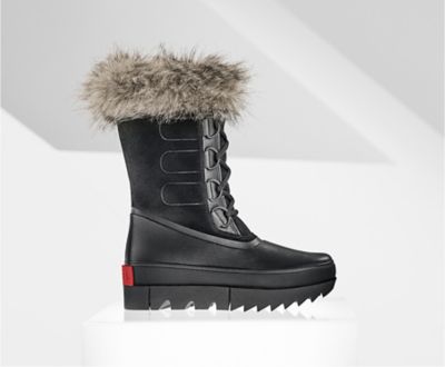 A profile view of a black Joan NEXT boot on white background