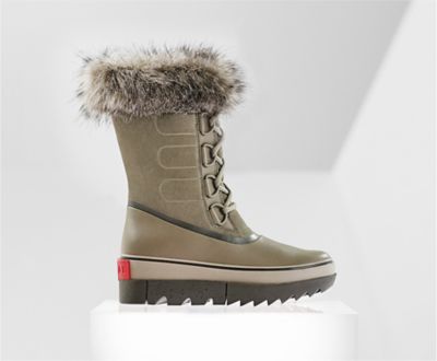 A profile view of a brown Joan NEXT boot on white background