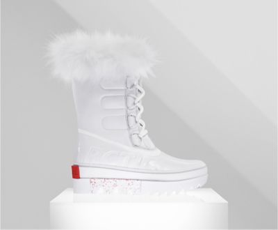 A profile view of a white Joan NEXT boot on white background
