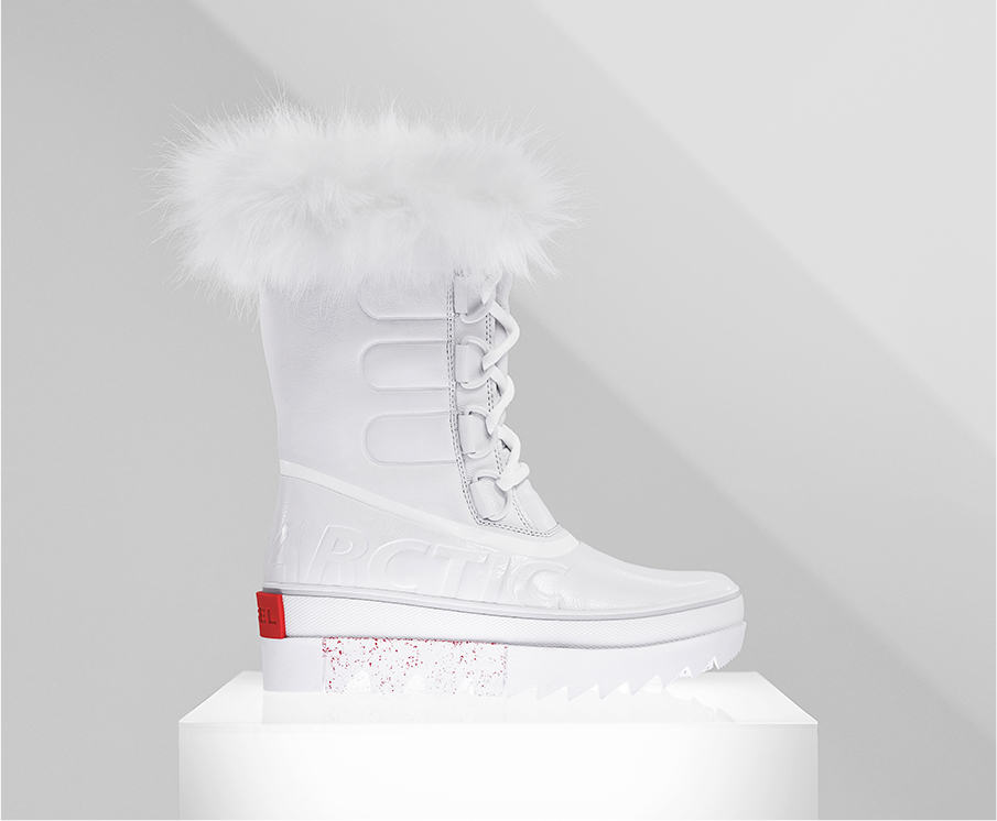 A profile view of a white Joan NEXT boot on white background