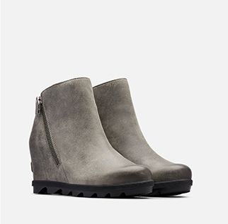 A pair of Joan Wedge Zip boots on a white background