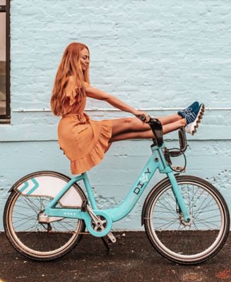 GIF of woman wearing new spring Lace Kinetic Sneaks while in city setting