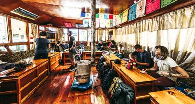 Mountain Hardwear crew takes a break from the Everest Base Camp trek in a tea house near Nimchi Valley, Nepal.